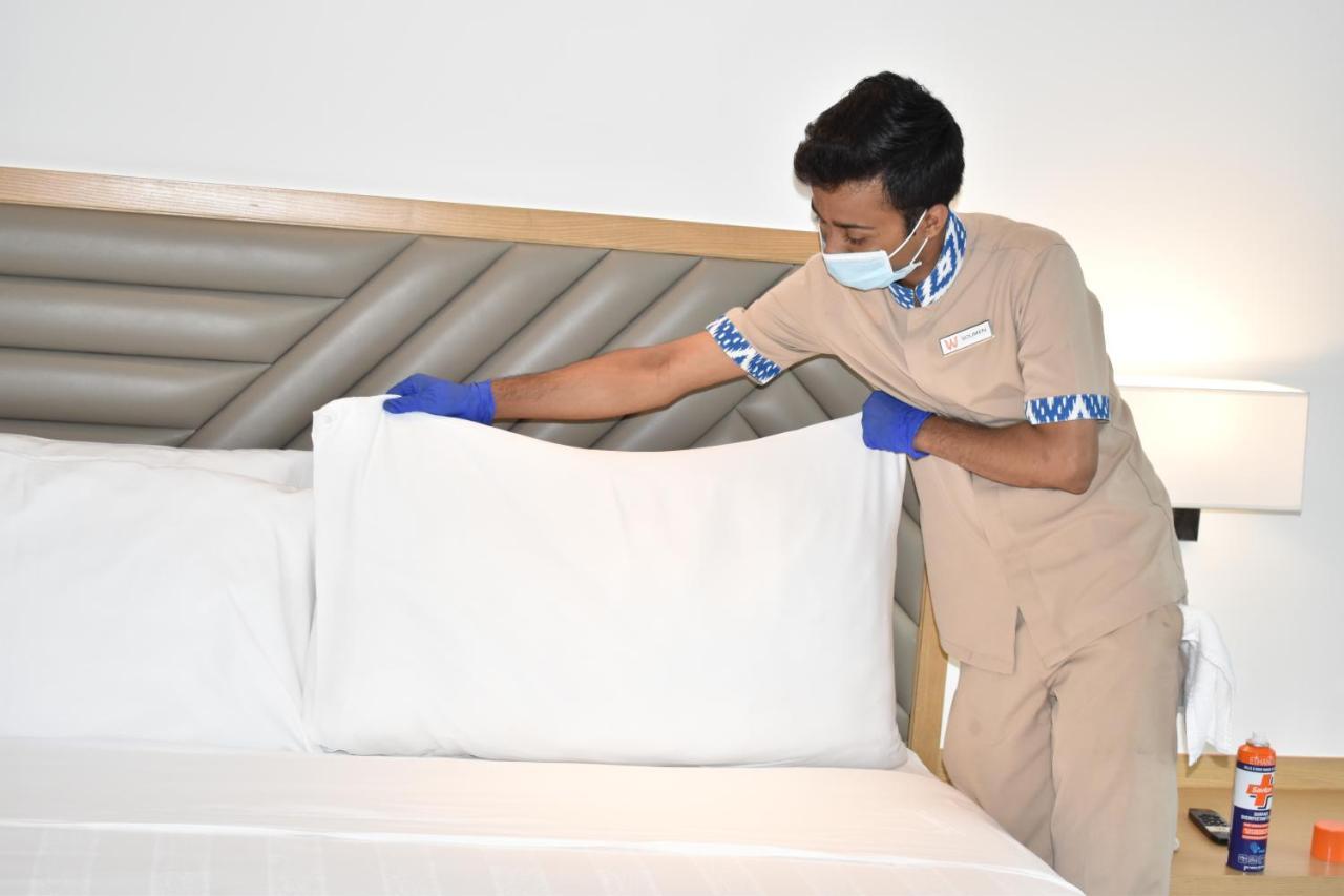 Welcomhotel By Itc Hotels, Racecourse, Kojambuttúr Kültér fotó A housekeeper making a bed